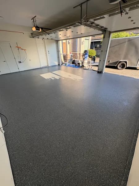 Basalt flake epoxy floor in a large garage with the doors open in Richmond, BC