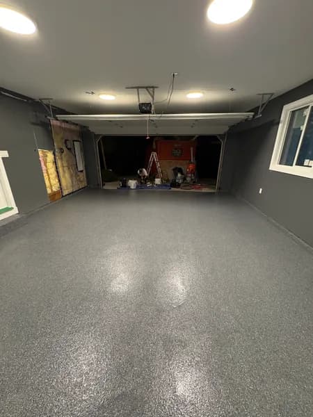 Basalt flake epoxy floor in a dark-walled garage in Surrey, BC