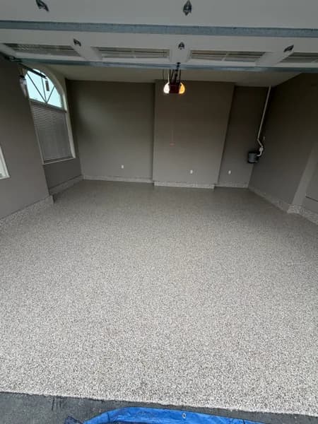 Bean flake epoxy floor in a tall garage with arched windows in Aldergrove, BC