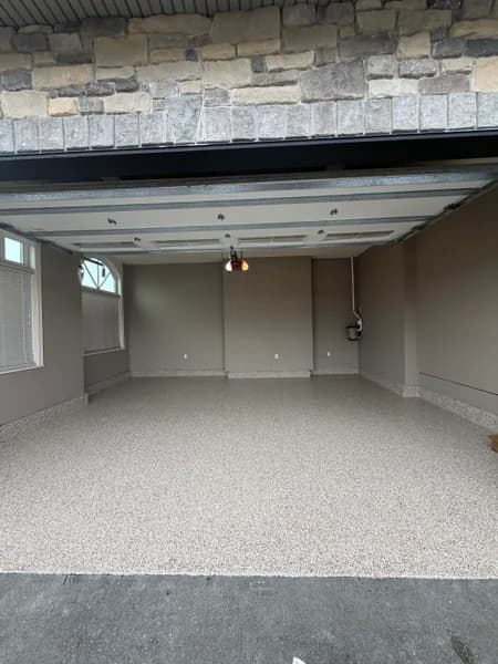 Bean flake epoxy garage floor seen from the open garage door in Aldergrove, BC