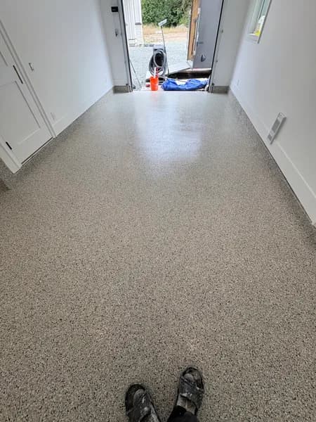 Cabin Fever flake epoxy floor in a long garage bay in Langley, BC