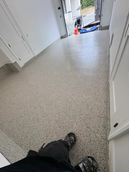 Cabin Fever flake epoxy garage floor looking toward the open door in Langley, BC