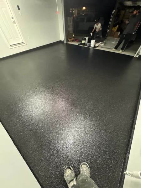 Carbon flake epoxy garage floor with white walls in Delta, BC