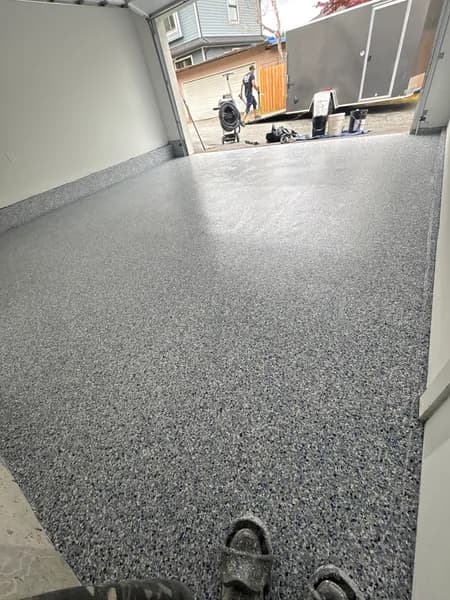 Comet flake epoxy garage floor looking toward the driveway in Burnaby, BC