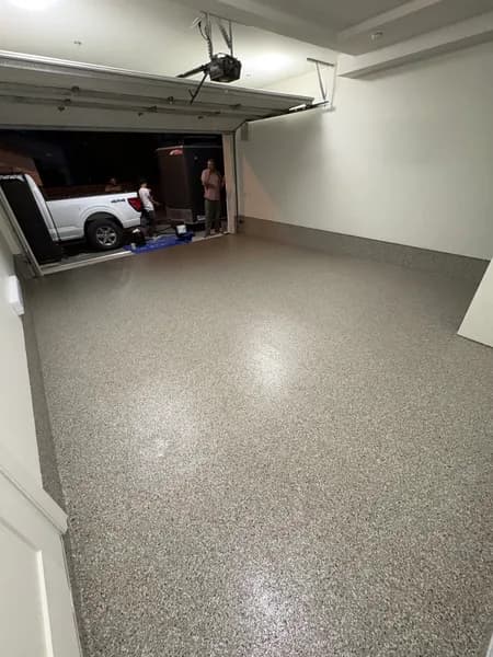 Creek Bed flake epoxy garage floor with the door open at night in Vancouver, BC