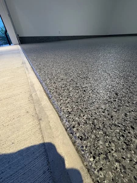 Multi-layer flake epoxy system on a polished concrete garage floor