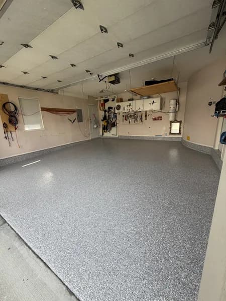 Blue-grey flake epoxy floor in a well-organized residential garage