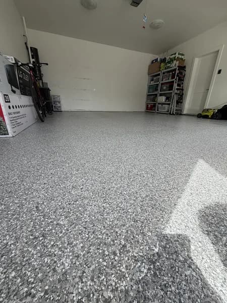 Grey flake epoxy garage floor with bike storage and shelving