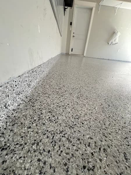 Close-up of a Gracious flake epoxy cove base in a Langley garage