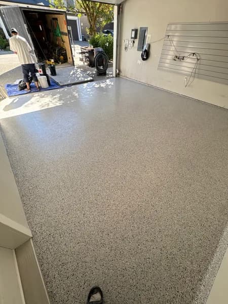 Gracious flake epoxy garage floor with slatwall storage in Langley, BC