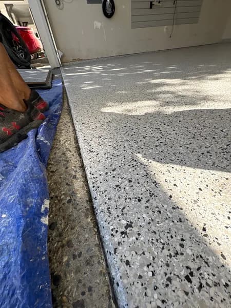 Close-up of Gracious flake epoxy at the garage door edge in Langley, BC