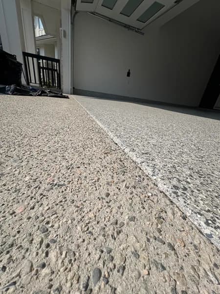 Gravel flake epoxy garage floor with a dark accent wall in Surrey, BC