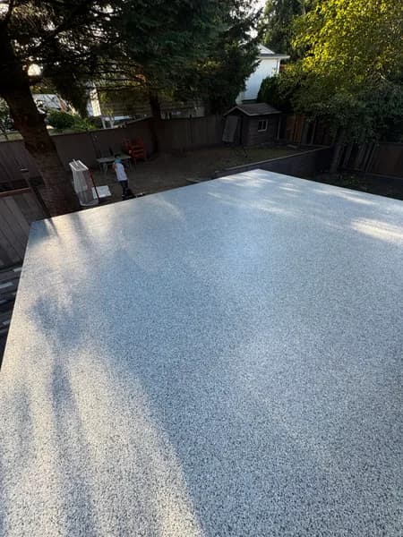 Sunlit Gravel flake epoxy patio surrounded by trees in Coquitlam, BC