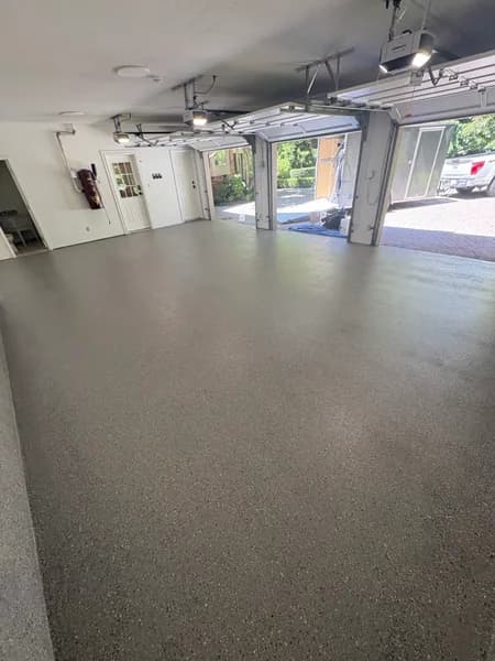 Hybrid flake epoxy floor in a three-car garage looking out to the driveway in West Vancouver, BC