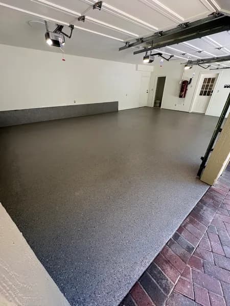 Hybrid flake epoxy three-car garage floor beside a brick driveway in West Vancouver, BC