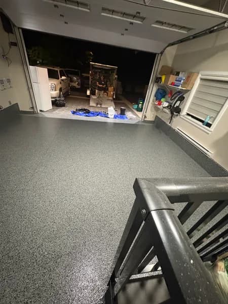 Nightfall flake epoxy garage floor seen from the stair railing in North Delta, BC