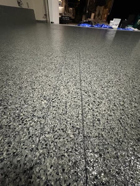 Close-up of Nightfall flake epoxy texture in a North Delta garage