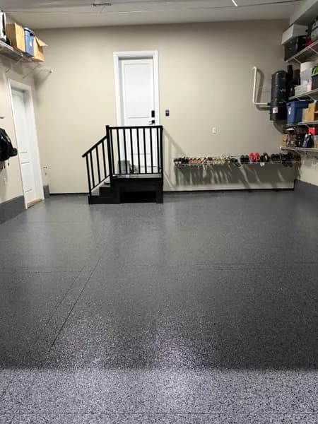 Nightfall flake epoxy garage floor with metal stairs and entry door in North Delta, BC