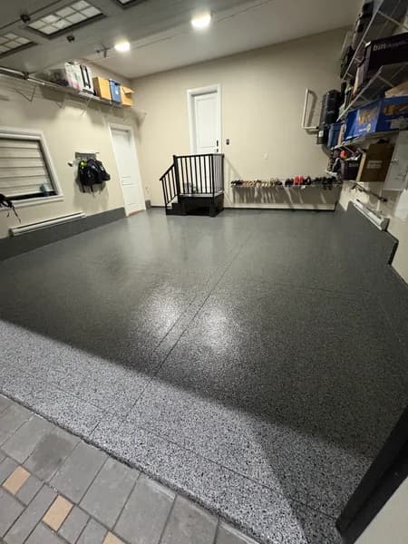 Nightfall flake epoxy garage floor beside a tiled entry in North Delta, BC