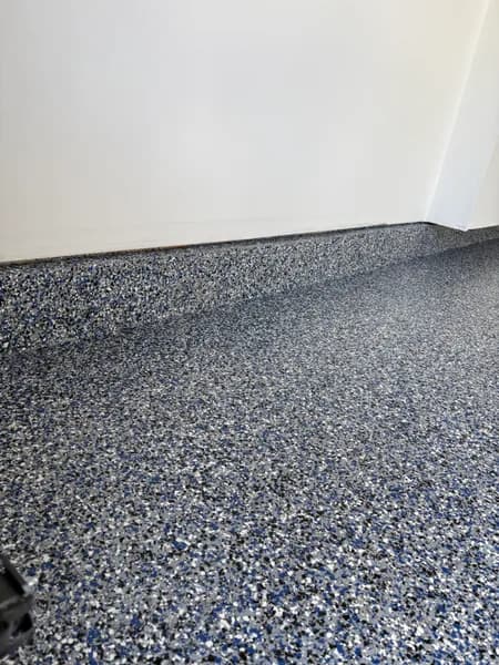 Close-up of an Orbit flake epoxy cove base in a Maple Ridge garage