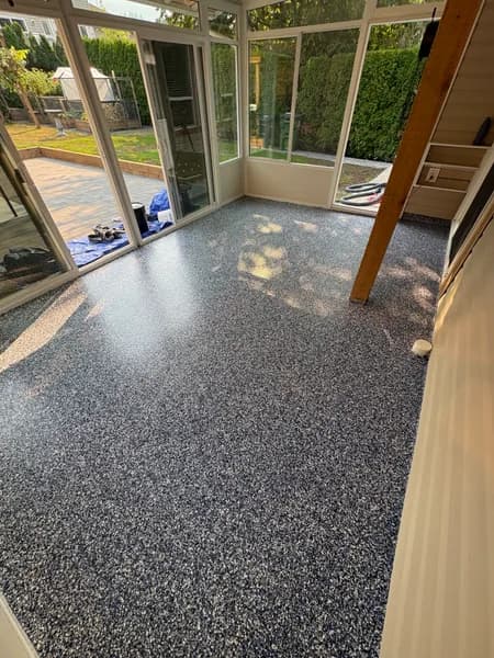Orbit flake epoxy floor on a glass-walled covered patio in Chilliwack, BC