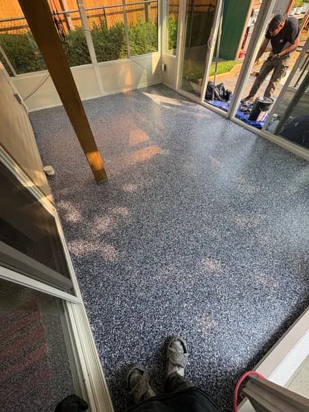 Wide view of an Orbit flake epoxy covered patio floor in Chilliwack, BC