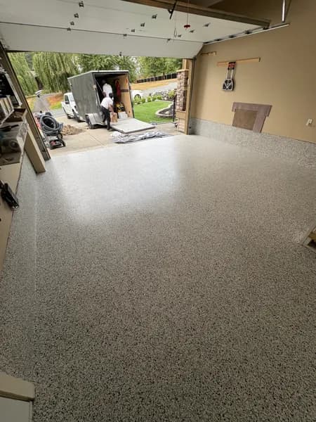 Quicksilver flake epoxy garage floor with the overhead door open in Chilliwack, BC