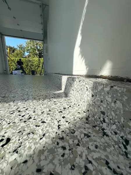 Low-angle close-up of Quicksilver flake epoxy at a Vancouver garage door