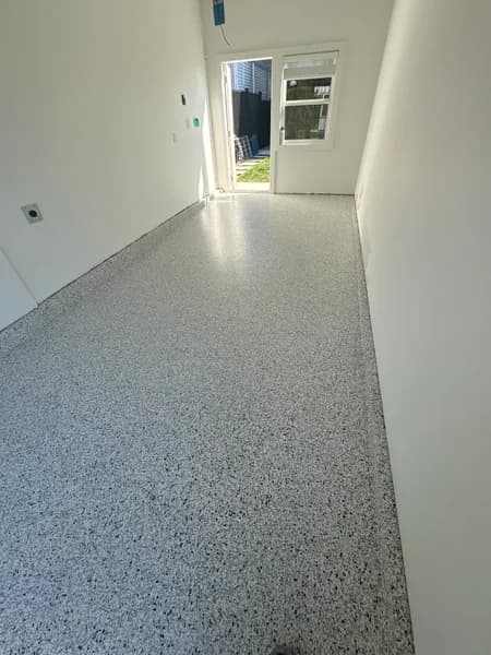 Quicksilver flake epoxy one-car garage floor looking toward the door in Vancouver, BC