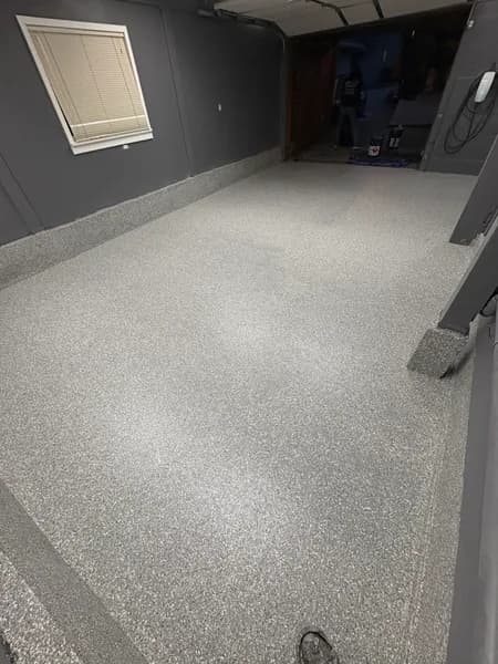 Stoney Creek flake epoxy garage floor by a window in North Vancouver, BC