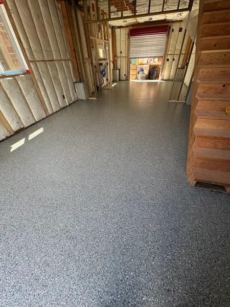 Thyme flake epoxy floor in a building with exposed framing in Vancouver, BC