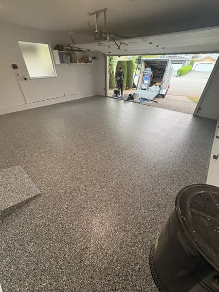 Wombat flake epoxy garage floor with the overhead door open in Richmond, BC