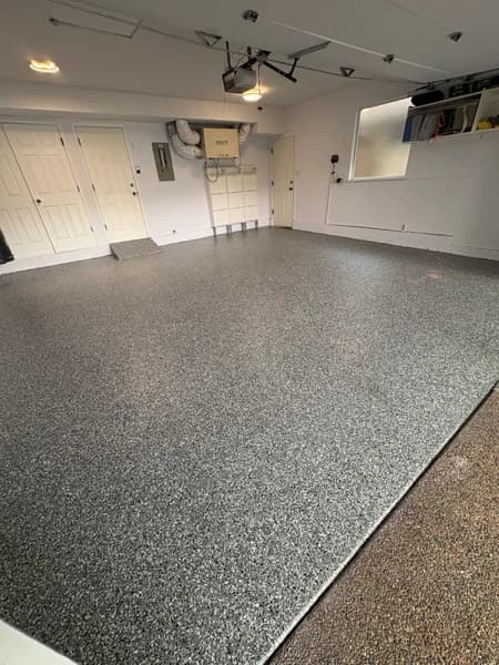 Wombat flake epoxy garage floor with white storage walls in Richmond, BC