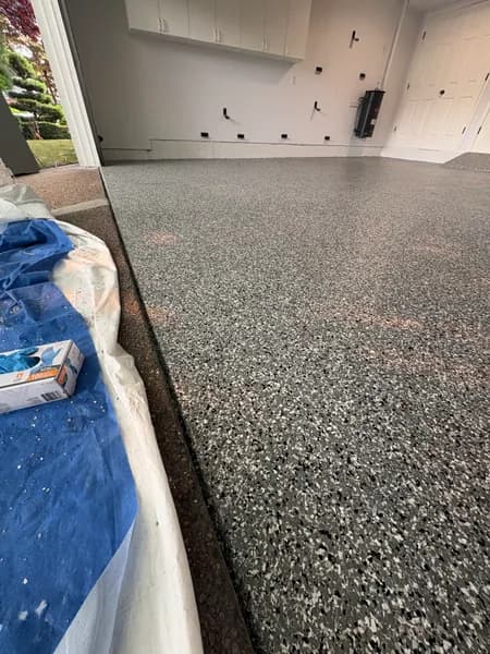Close-up of a Wombat flake epoxy garage edge in Richmond, BC