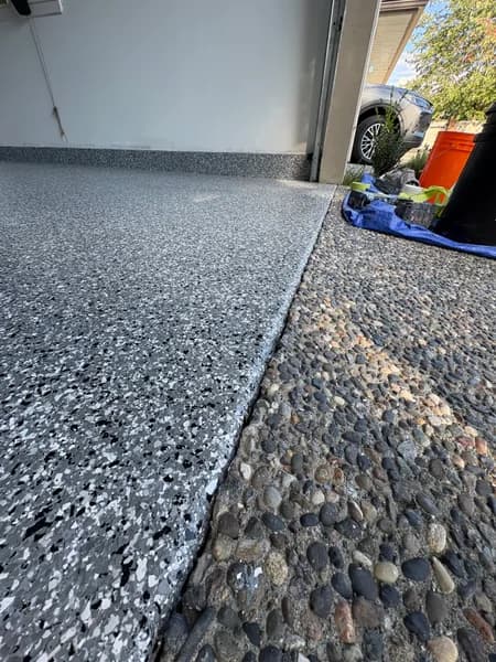 Wombat flake epoxy garage edge meeting an aggregate driveway in Vancouver, BC
