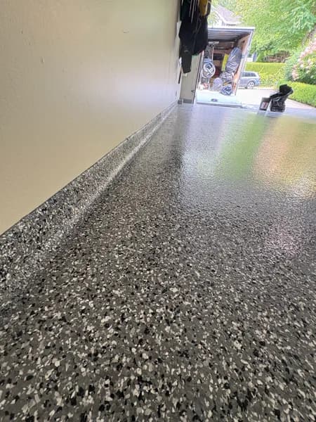 Close-up of Wombat flake epoxy cove base along a garage wall in West Vancouver, BC