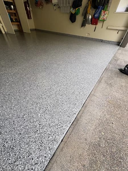 Wombat flake epoxy garage floor meeting the concrete driveway in West Vancouver, BC