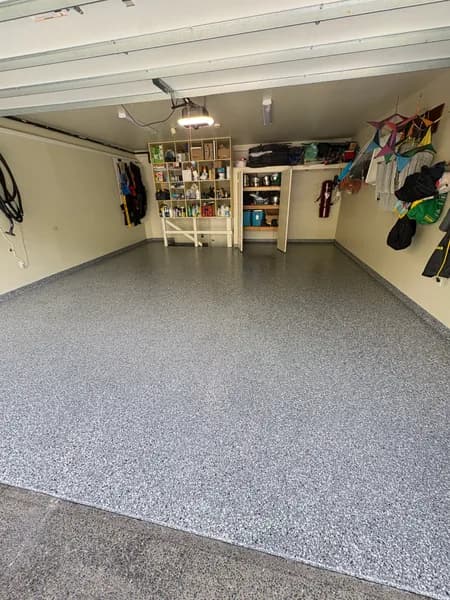 Organized garage with a Wombat flake epoxy floor and cove base in West Vancouver, BC