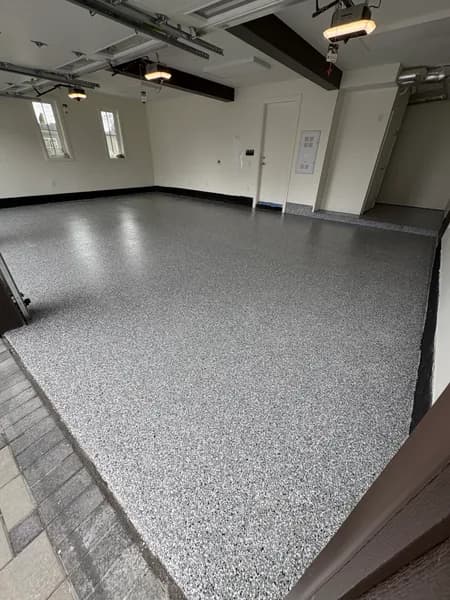 Wombat flake epoxy garage floor beside a paver driveway in White Rock, BC