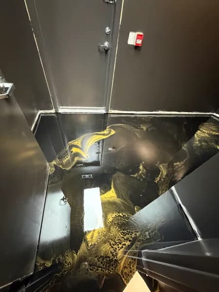 Gold veining in a black metallic epoxy store floor in downtown Vancouver