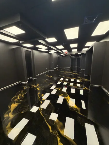 Black and gold metallic epoxy floor with high-gloss topcoat in a downtown Vancouver shop