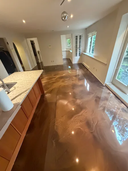 High-gloss bronze metallic epoxy floor running the length of a Vancouver basement suite
