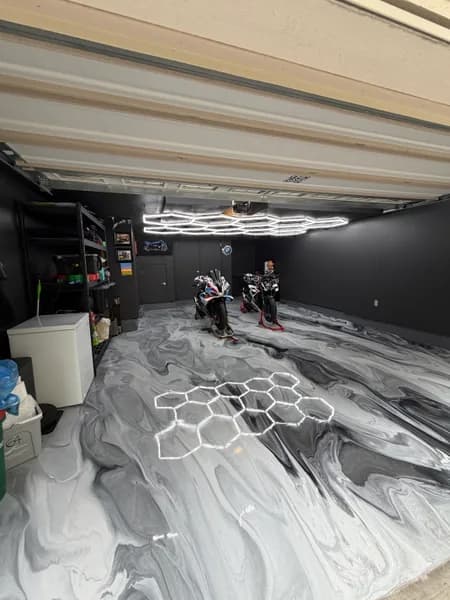 Grey and white metallic epoxy garage floor under hexagon lights in Richmond, BC