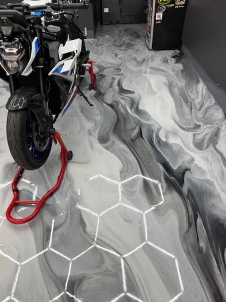 Motorcycle on a grey and white metallic epoxy garage floor in Richmond, BC