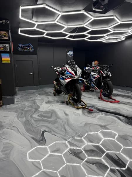Motorcycles on a grey and white metallic epoxy floor in a Richmond garage
