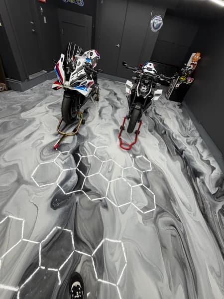 Grey and white metallic epoxy motorcycle garage floor with hexagon lighting in Richmond, BC