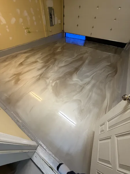 Metallic epoxy floor with reflective pearl finish in a commercial space