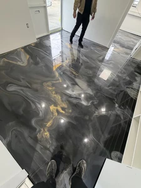 Metallic epoxy floor with blue-grey swirl pattern in a retail interior