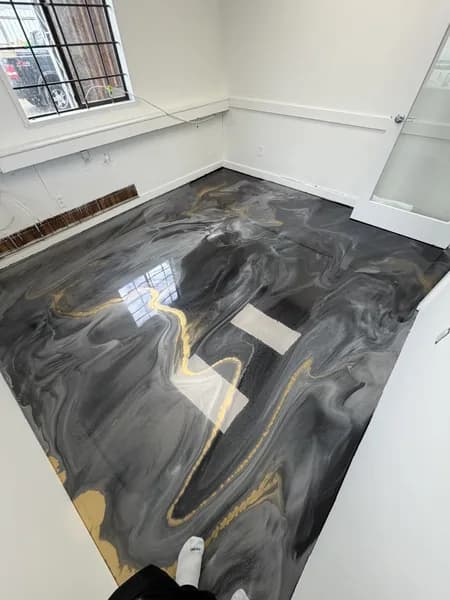 Custom metallic epoxy floor with warm bronze tones installed by Go2Epoxy