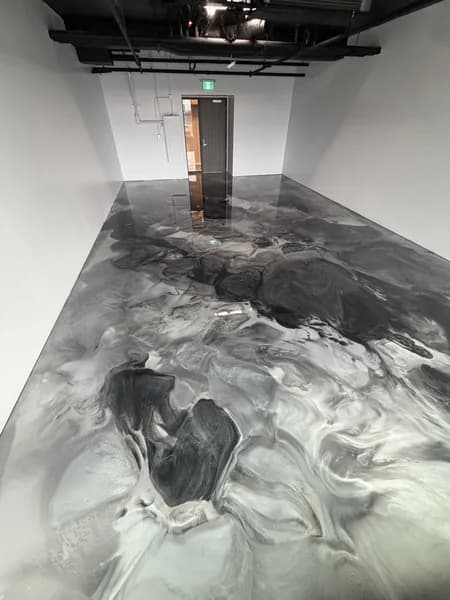 Seamless metallic epoxy floor in a modern showroom space